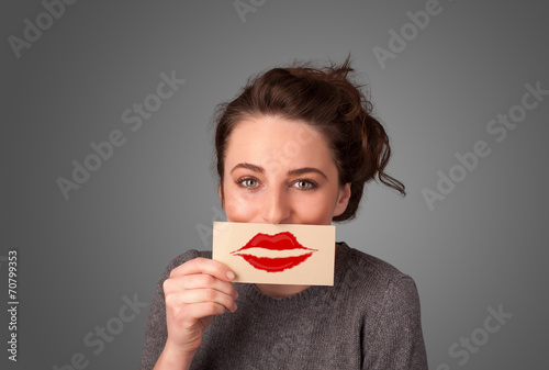 Happy pretty woman holding card with kiss lipstick mark