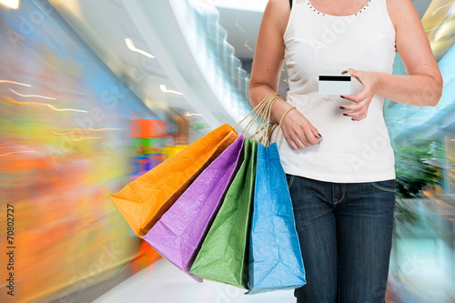 Woman holding shopping bags and credit card