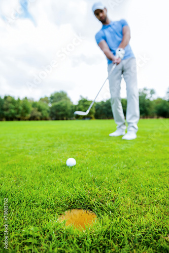 Golfer putting.