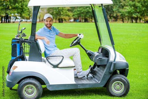 Man driving golf cart.