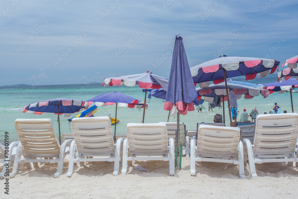 lounge chairs with umbrella on a beach