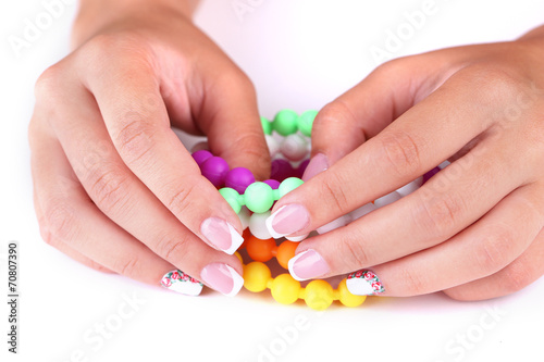 Female hand with stylish colorful nails  with decorative flower