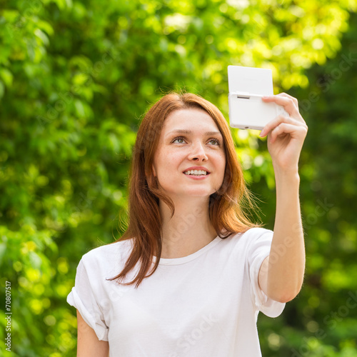 Young girl taking a selfie photo with beautiful bokeh © beerlogoff