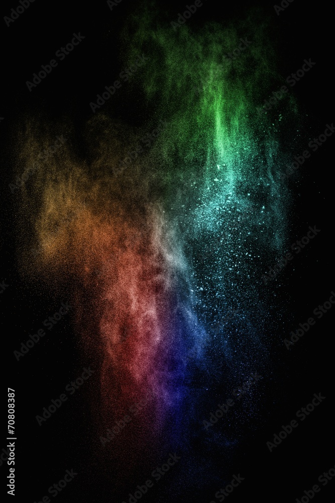 Colourful powder exploding isolated on black
