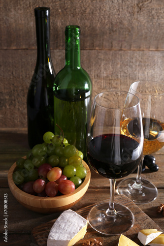 beautiful still life with wine, cheese and ripe grape