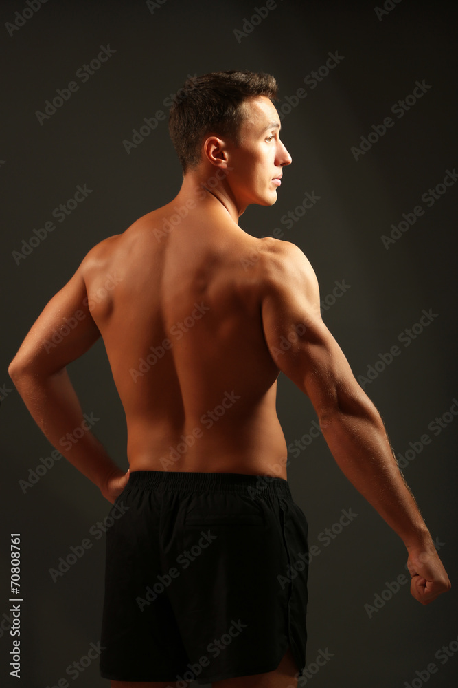 Fototapeta premium Handsome muscle young man on dark background