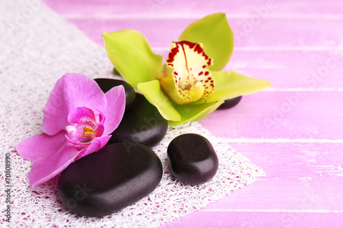 Fototapeta Naklejka Na Ścianę i Meble -  Pink tropical orchid flowers on color wooden background