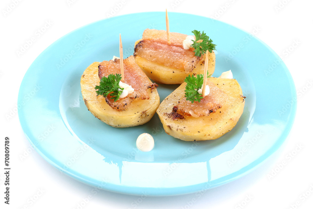Baked potato with bacon on plate, isolated on white