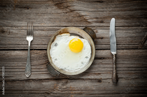 Top view of fried egg on wooden