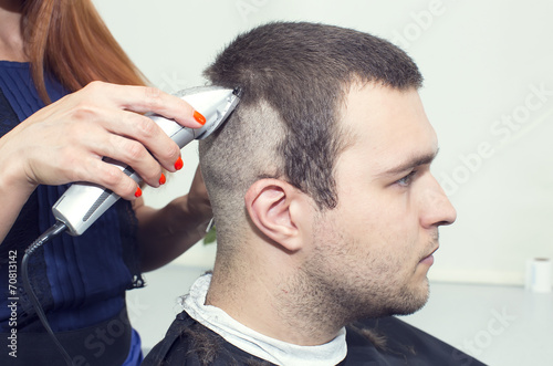 young man in a barber shaved shorn