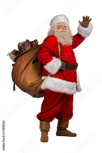Santa Claus carrying big bag full of gifts