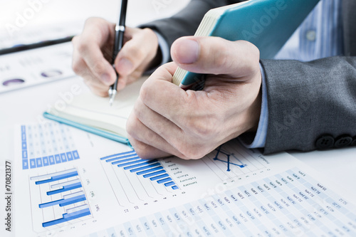 Businessman analyzing investment charts. Accounting