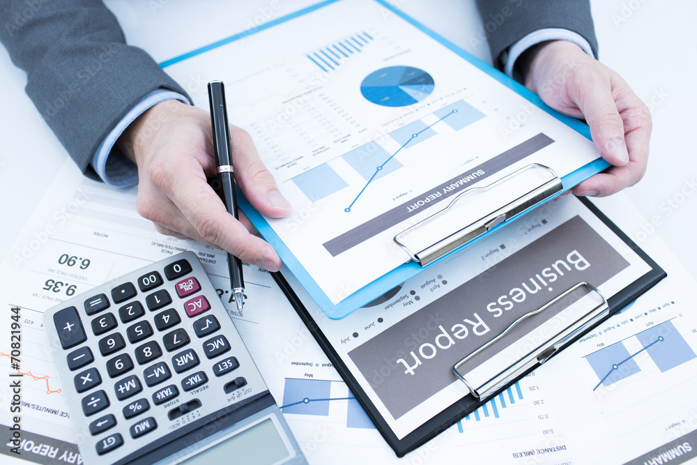 Close-up of graphs and charts analyzed by businessman Close-up of graphs and charts analyzed by businessman