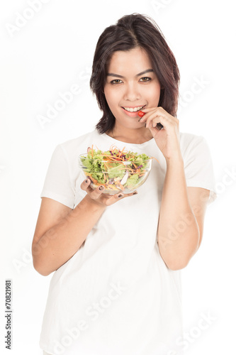 Pretty girl eating fresh vegetable salad
