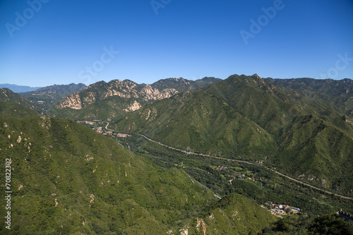 Mountain landscape. In the background is the Great Wall of China