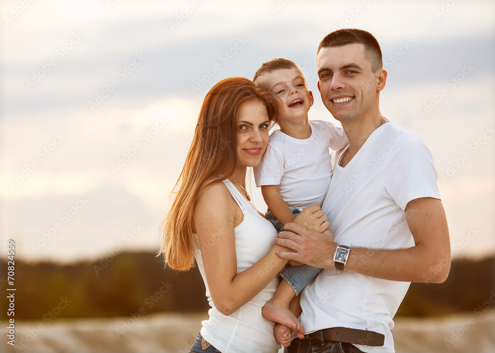 Happy beautiful family on sunset smiling Happy beautiful family on sunset smiling