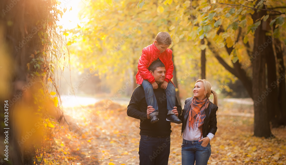 Fototapeta premium happy family walking in autumn park. 