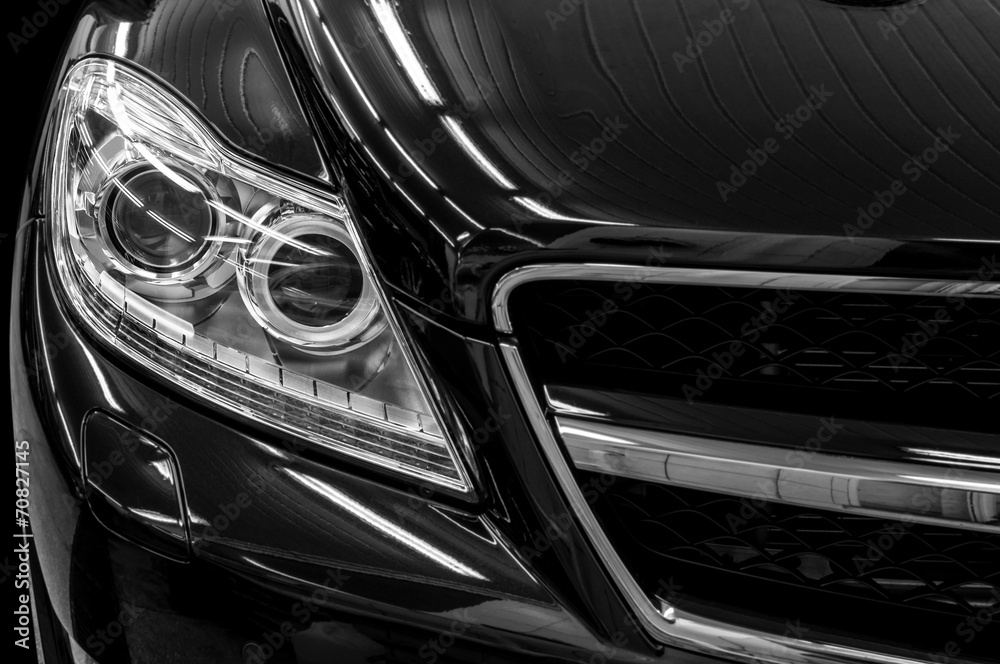 Closeup headlights of business car. Exterior detail.