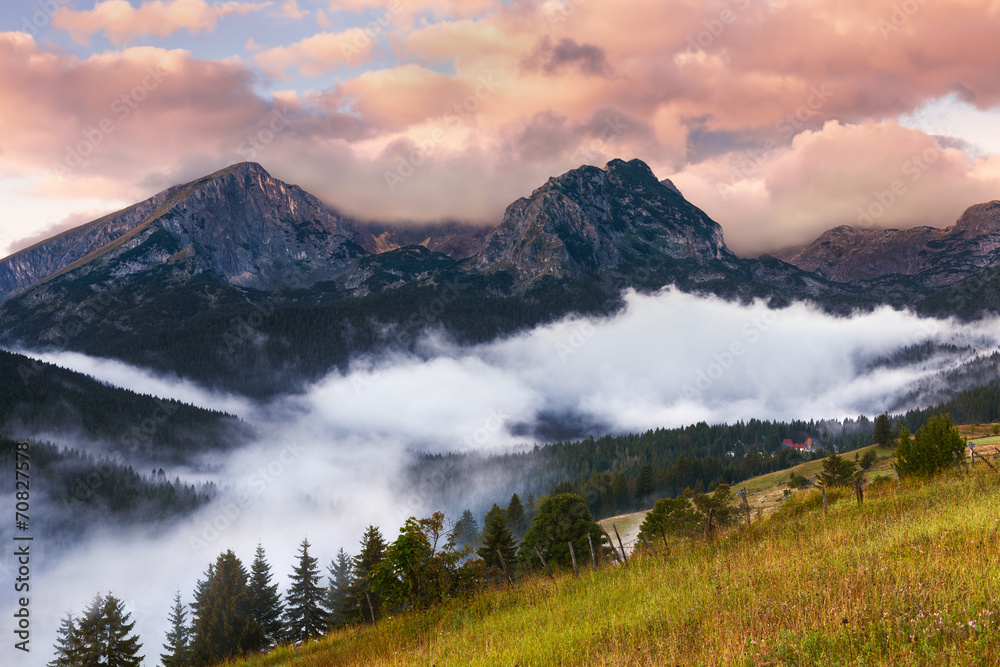Foggy sunrise with a view of the mountain peaks