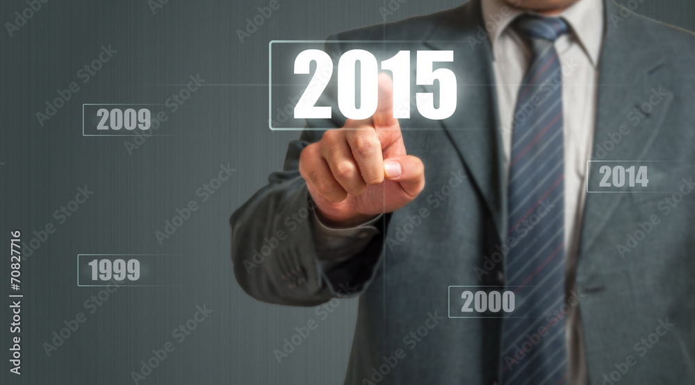 Business Man Touching An Imaginary Screen And Choosing 2015 Year