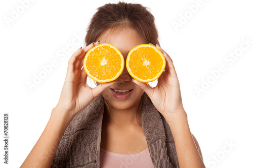Asian healthy workout girl put orange over her eyes