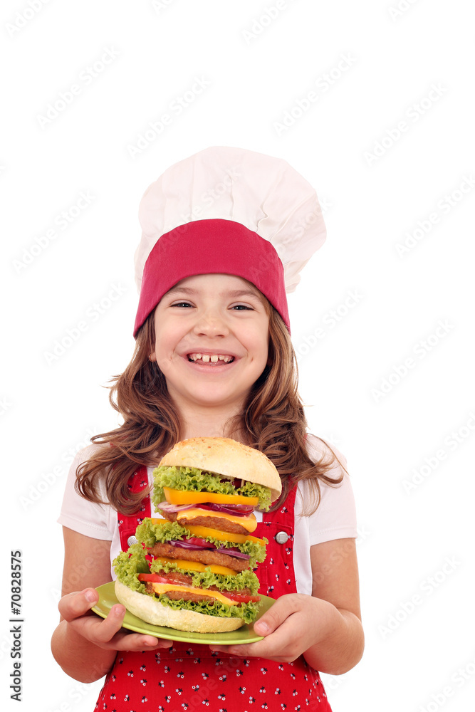 happy little girl cook holding a big hamburger happy little girl cook holding a big hamburger