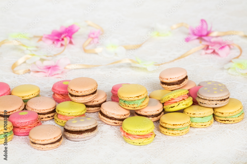 Colorful cookies with cream on table with ribbon Colorful cookies with cream on table with ribbon