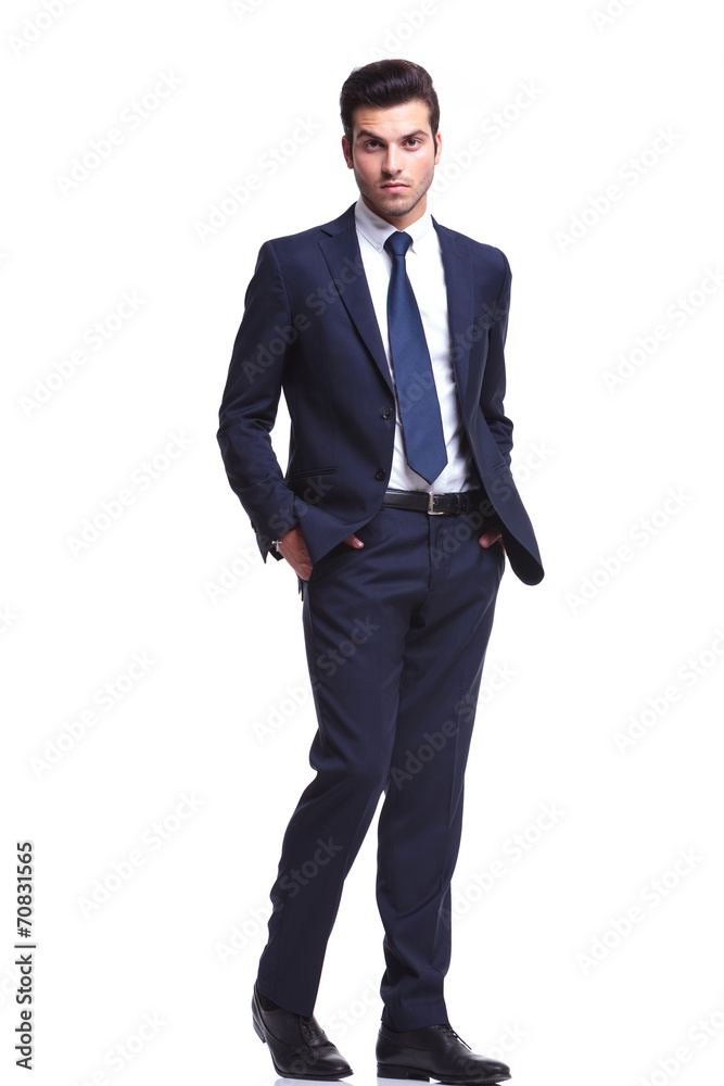elegant business man walking with his hands in his pocket elegant business man walking with his hands in his pocket