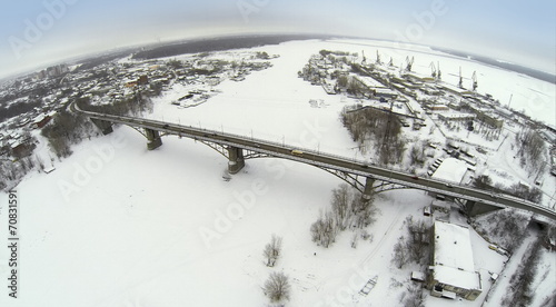 Aerial view to highway bridge over the frozen river