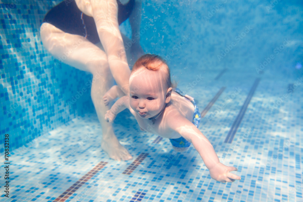 beautiful little girl swims underwater. child development