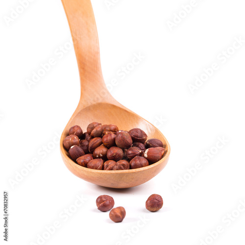 Wooden spoon with nuts.
