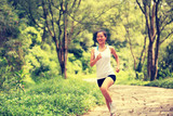 fitness woman runner running on stone trail