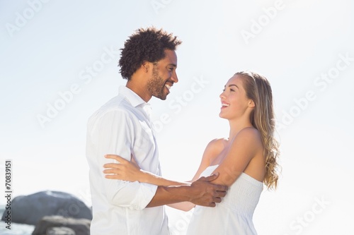 Gorgeous couple embracing at the coast