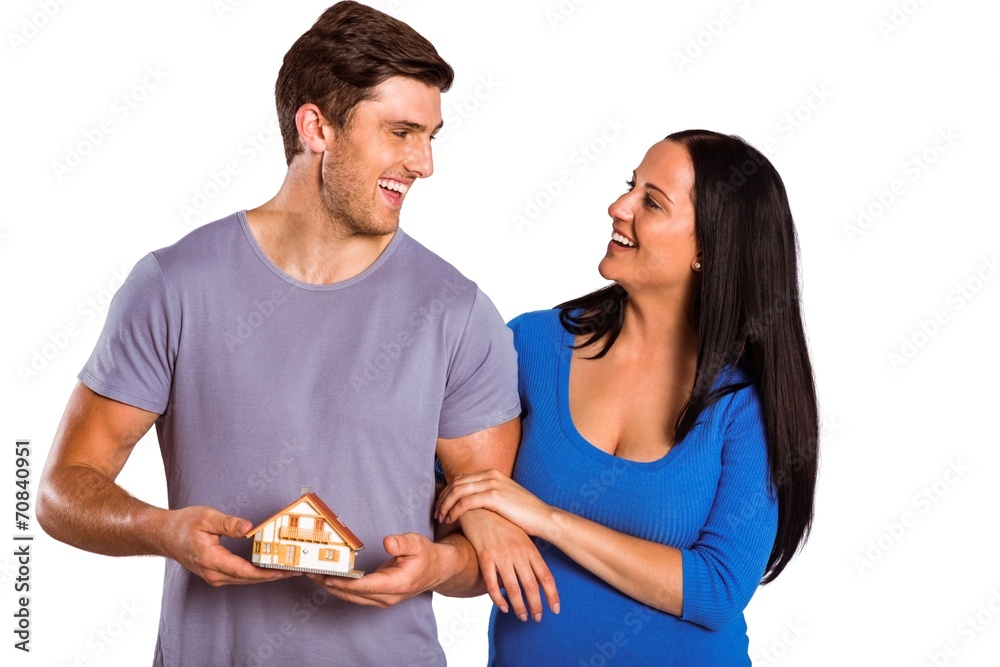Young couple holding a model house