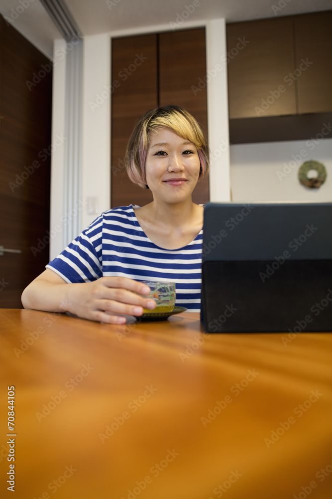 A woman sitting at a table with a laptop computer. A woman sitting at a table with a laptop computer.