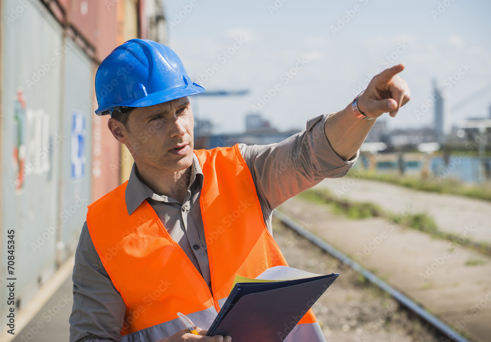 Portrait of man with blue safety helmet checking cargo containers Portrait of man with blue safety helmet checking cargo containers