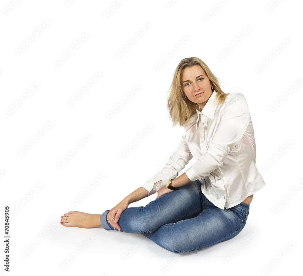 Portrait of attractive young blond woman sitting on floor Portrait of attractive young blond woman sitting on floor