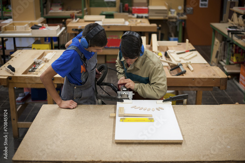 Vocational school students working in a carpenter's workshop