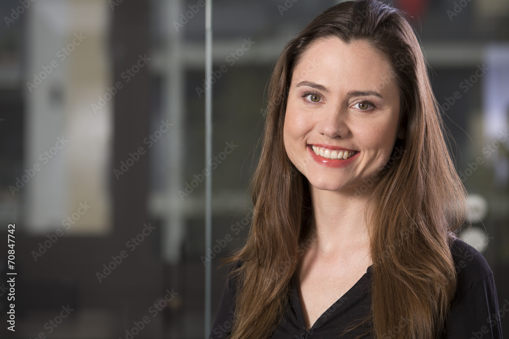 Portrait of smiling business woman in front of glass pane Portrait of smiling business woman in front of glass pane