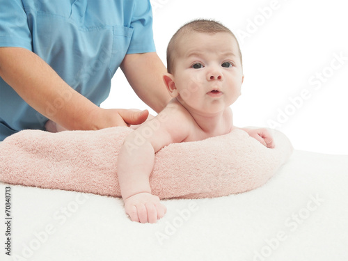 Doctor massage small caucasian baby isolated