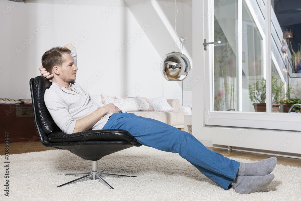 Man relaxing in armchair after work Man relaxing in armchair after work