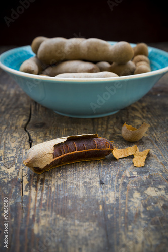 Bowl of tamarinds Tamarindus indica on wooden table photo