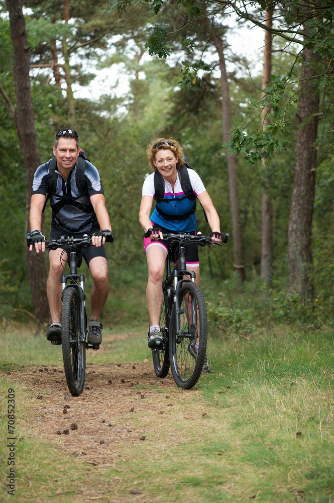Happy couple cycling in nature