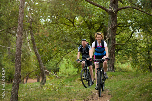 Healthy couple enjoying a bike ride in nature