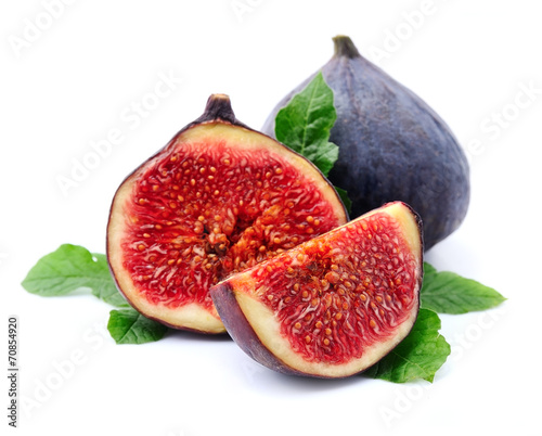 Ripe figs with leaves on the white background.
