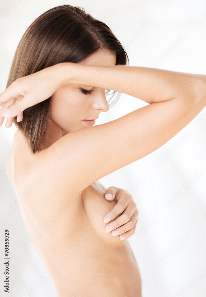 Fototapeta premium woman checking breast for signs of cancer