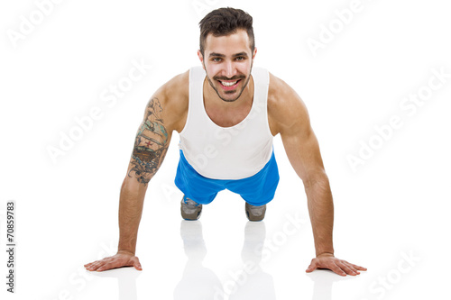 Athletic man making pushups © ikostudio