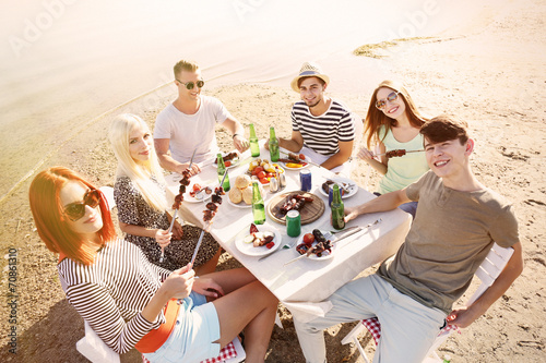 Happy friends on rest at beach