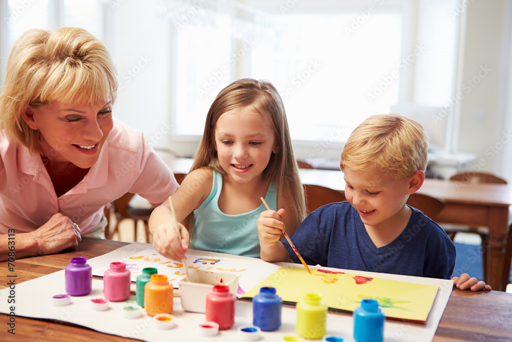 Grandmother Painting Picture With Grandchildren At Home Grandmother Painting Picture With Grandchildren At Home