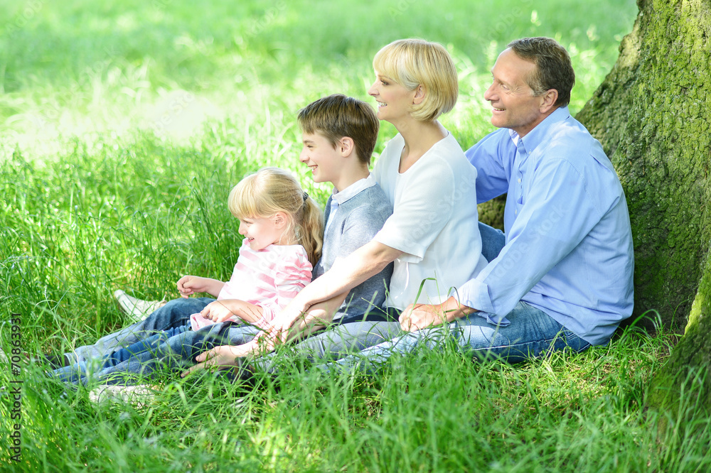 Fototapeta premium Happy family relaxing in park